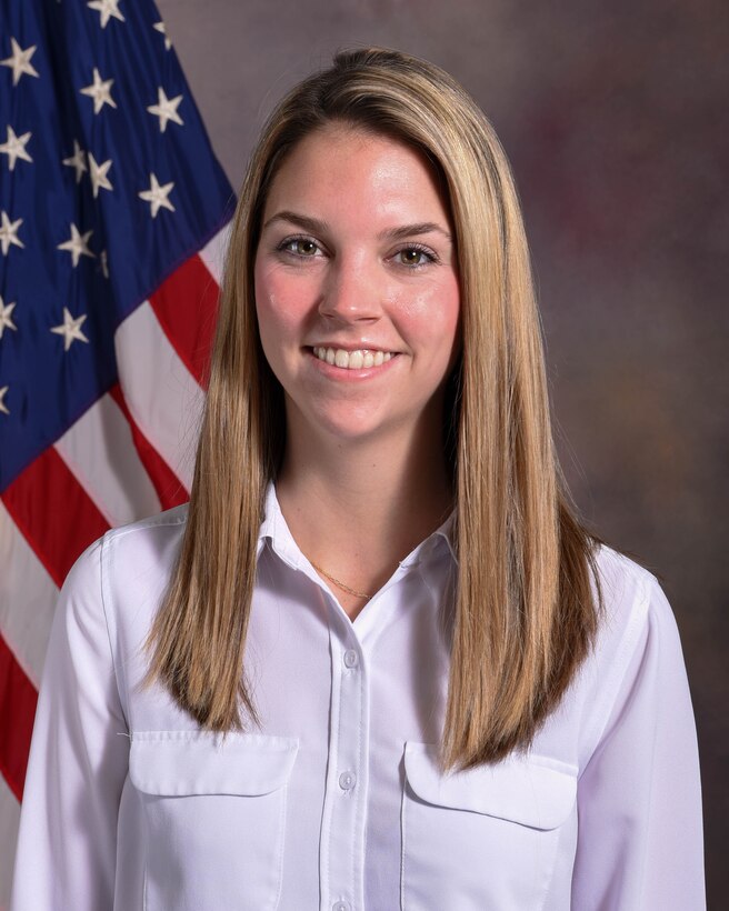 Photo of NDU employee in front of an American flag