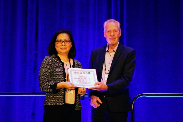 KISSIMMEE, Fla. (Aug. 29, 2024) Dr. Annette Rodriiguez, with Naval Medical Research Unit (NAMRU) San Antonio, receives a second-place award for poster sessions two at the Military Health System Research Symposium (MHSRS). MHSRS is the Department of Defense's premier scientific meeting that focuses specifically on the unique medical needs of service members. This annual educational symposium brings together healthcare professionals, researchers, and DoD leaders for four days of critical learning, intensive idea sharing and relationship building. Navy Medicine Research and Development attended MHSRS and participated in breakout sessions, poster presentations, lectures, and manned booths in the exhibit hall. The eight Navy Medicine Research and Development commands, led by Naval Medical Research Command (NMRC), and consisting of Naval Health Research Center (NHRC), Naval Submarine Medical Research Laboratory (NSMRL) and NAMRUs Dayton, San Antonio, EURAFCENT, INDO PACIFIC, and SOUTH, are engaged in a broad spectrum of activity from basic science in the laboratory to field studies in austere and remote areas of the world to investigations in operational environments. In support of the Navy, Marine Corps and joint U.S. warfighters, researchers study infectious diseases, biological warfare detection and defense, combat casualty care, environmental health concerns, aerospace and undersea medicine, medical modeling, simulation, operational mission support, epidemiology and behavioral sciences.  (U.S. Navy Photo by Sidney Hinds/released)