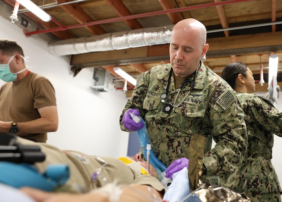 240827-N-DE439-1195 KEFLAVIK AIR BASE, Iceland (Aug. 27, 2024) Cmdr. Eliot D. Spencer, Certified Registered Nurse Anesthetists, prepares patient for surgery during a simulated medical training as part of exercise Northern Viking 24 (NV24) on Keflavik Air Base, Iceland, Aug. 27, 2024. NV24 strengthens interoperability and force readiness between the U.S., Iceland and Allied nations, enabling multi-domain command and control of joint and coalition forces in the defense of Iceland and sea lines of communication in the Greenland, Iceland, United Kingdom (GIUK) gap. (U.S. Navy photo by Mass Communication Specialist 1st Class Almagissel Schuring)