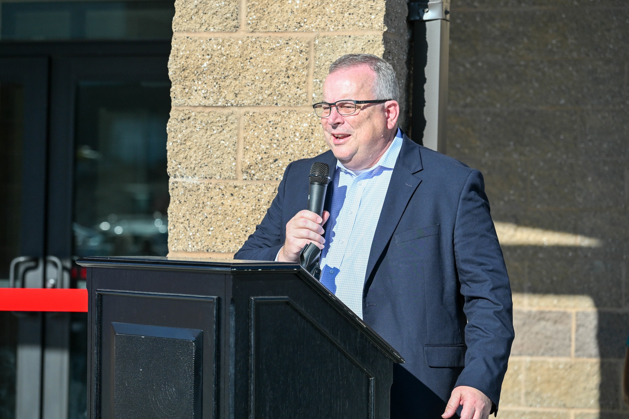 A man stands a podium to deliver a speech