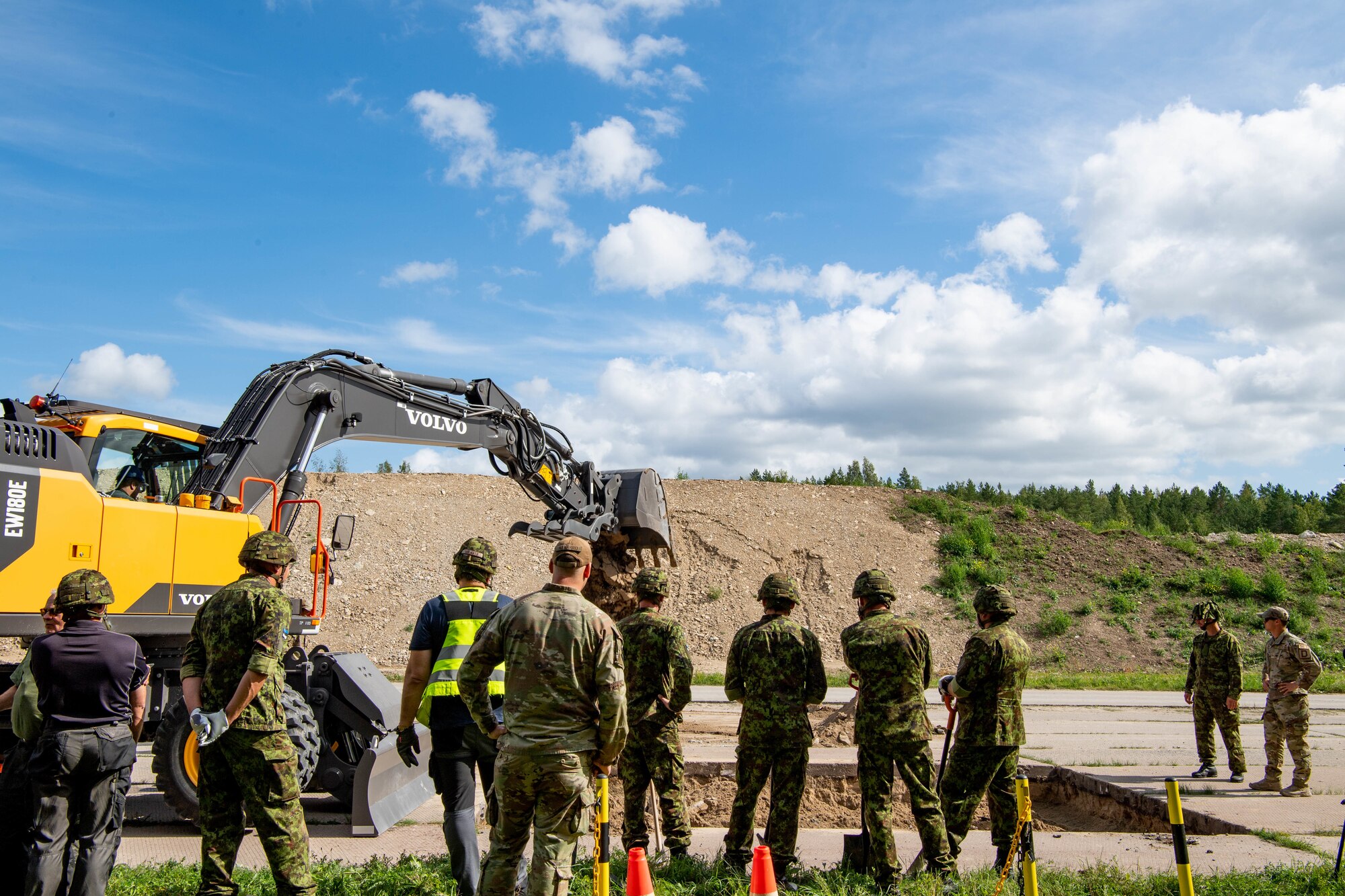 Members watch a hole get dug