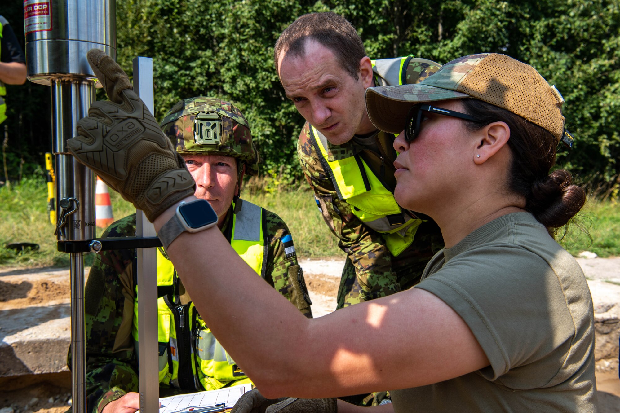 Airman points at a weight device