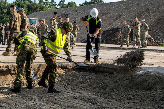 members shovel dirt