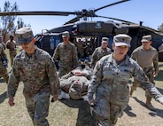 Texas Army National Guard and Chilean army soldiers carry a litter off a U.S. UH-60 Black Hawk helicopter while conducting medical evacuation training during Southern Fenix 24 at Campo Militar Pozo Almonte, Chile, Aug. 29, 2024.
