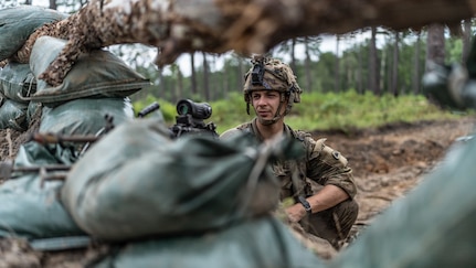 Pfc. Braden Whitlock, an M249 SAW gunner with Alpha Company, 1st Battalion, 186th Infantry Regiment, scans his sector of fire from a newly constructed fighting position during the Joint Readiness Training Center rotation 24-09 at Fort Johnson, La., July 28, 2024. The training exercise focused on large-scale combat operations as part of the 41st Infantry Brigade Combat Team's Annual Training.