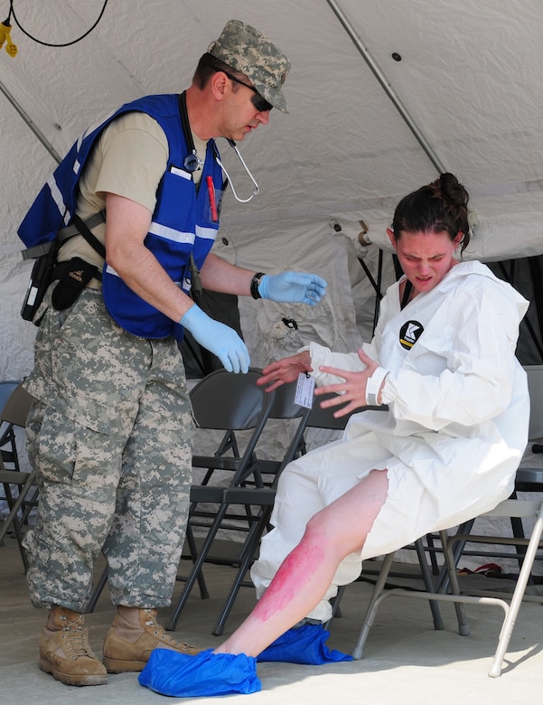 Lt. Col. Dan A. Manning, a physician assistant, assesses a mock casualty as part of the Kentucky National Guard Chemical Radiological Nuclear High-Yield Explosives Enhanced Response Force Package training May 23 at Muscatatack Urban Training Center, Butlerville, Ind.