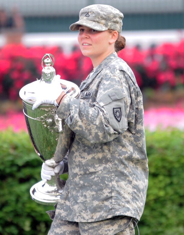 Kentucky National Guard Pfc. Kara Denise Bucklew, a military policeman with the 223rd Military Police Company stationed in Louisville, Ky., moves the winner's trophy for the Kentucky Oaks race to the winner's circle at Churchill Downs, May 4, 2012.