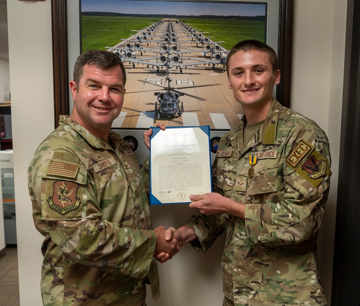 U.S. Air Force Col. Paul Sheets, 23rd Wing commander, left, presents the Air and Space commendation medal to Airman 1st Class Trace Drugolenski, 347th Operations Support Squadron commander’s enlisted executive, at Moody Air Force Base, Georgia, Aug. 23, 2024. Drugolenski was instrumental in rescuing the life of a drowning victim while on leave. (U.S. Air Force photo by Senior Airman Leonid Soubbotine)