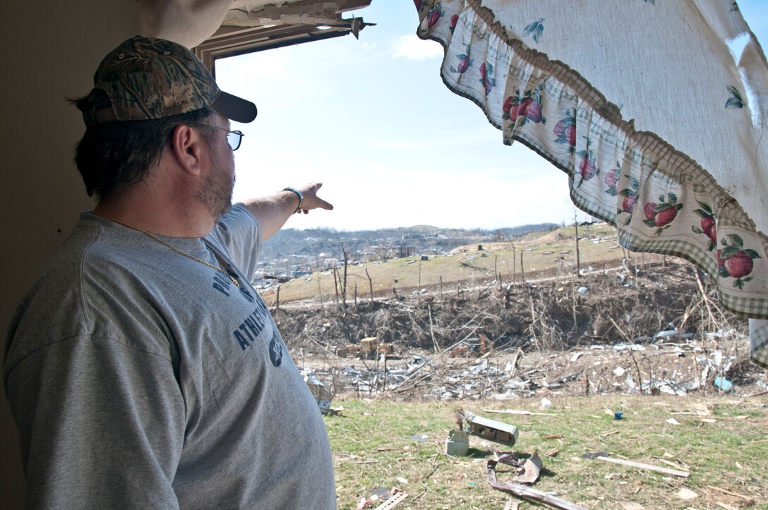 West Liberty, Ky., resident Daniel Leach points to where he viewed an EF3 tornado ravaging his hometown before it slammed into his apartment building. Leach went through what was left of his apartment and belongings, March 7, five days after the storm ripped through his Eastern Kentucky community, March 2, killing five residents.