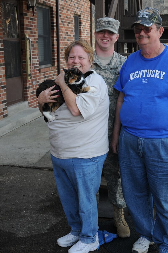 Kentucky National Guard Sgt. Sean Durban, 301st Chemical Company, is happy that he was able to rescue Prissy the cat for Eddie and Sandi Lawson, March 7. The feline spent five days alone after a tornado ripped part of the roof off of the Lawson's home March 2, and devastated most of the town of West Liberty, Ky.