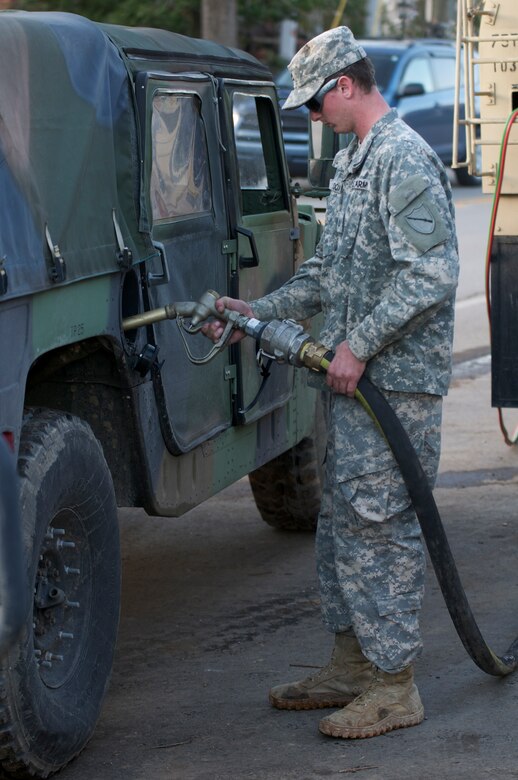 Kentucky National Guard Pfc. Lance S. Cox, a refueler assigned to the Maysville, Ky.-based 299th Chemical Company, fules a Humvee, March 6, in West Liberty, Ky., during tornado relief efforts. Elements from the 103rd Chemical Battalion responded hours after a tornado ravaged West Liberty, March 2, and continued to provide law enforcement and humanitarian support in the week after the storm. Cox's mission was to refuel anything that needed diesel fuel to include generators at the local hospital and incident command trailers as well as military and power company trucks.