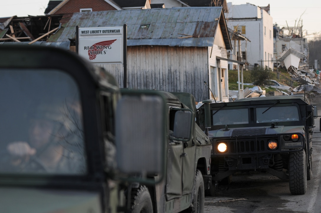 A Kentucky National Guard convoy, made up of soldiers from the 103rd Chemical Battalion, stage at a refueling point in West Liberty, Ky., March 6. The Guardsmen reported for duty hours after an EF3 tornado ravaged the Appalachian community and provided relief and recovery, security and humanitarian operations in the days after the storm.