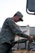 Kentucky National Guard Pfc. Lance S. Cox, a refueler assigned to the Maysville, Ky.-based 299th Chemical Company, fules a Humvee, March 6, in West Liberty, Ky., during tornado relief efforts. Elements from the 103rd Chemical Battalion responded hours after a tornado ravaged West Liberty, March 2, and continued to provide law enforcement and humanitarian support in the week after the storm. Cox's mission was to refuel anything that needed diesel fuel to include generators at the local hospital and incident command trailers as well as military and power company trucks.