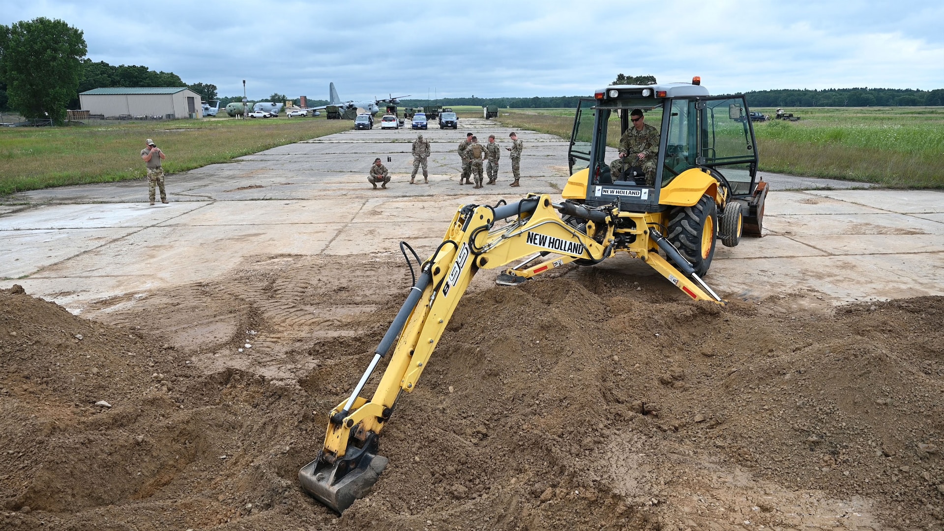 Airmen assigned to the 178th Civil engineering squadron provide training on excavation equipment during a rapid airfield damage response exercise Aug. 8 during Northern Lightning at Volk Field, Wis. This two-week long exercise provides more than 1,500 joint-force service members with tactical and multi-capable training. U.S. Air National Guard photo by Senior Airman Colin Simpson