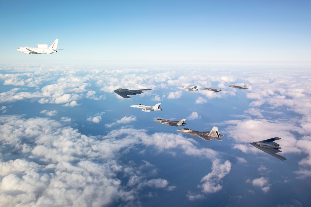 U.S. Air Force B-2 Bombers and F-22 Raptors fly in formation with an Australian air force E-7A Wedgetail, EA-18G Growlers and F-35A Lightning II jets over Royal Air Force Base Williamtown, Australia, Aug. 19, 2024.