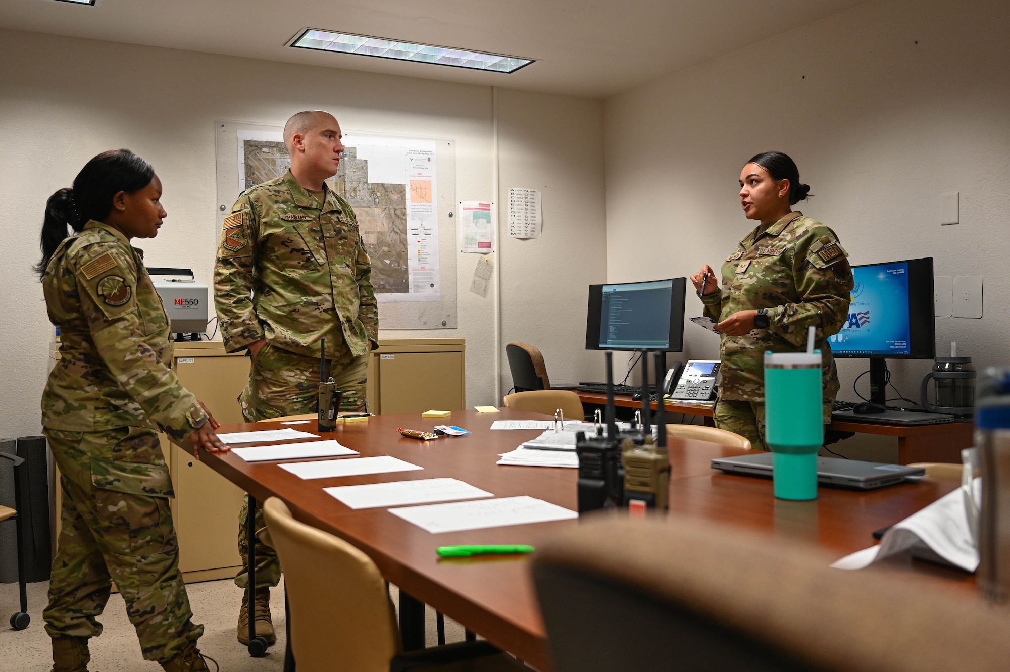 U.S. Air Force Airmen assigned to the 355th Medical Group review policies and procedures in the medical command center during exercise Mosaic Lightning at Davis-Monthan Air Force Base, Arizona, Aug. 21, 2024. The 355th MDG had a simulated outbreak of Anthrax and then enacted by a response team to combat the threat. (U.S. Air Force photo by Senior Airman Andrew Garavito)
