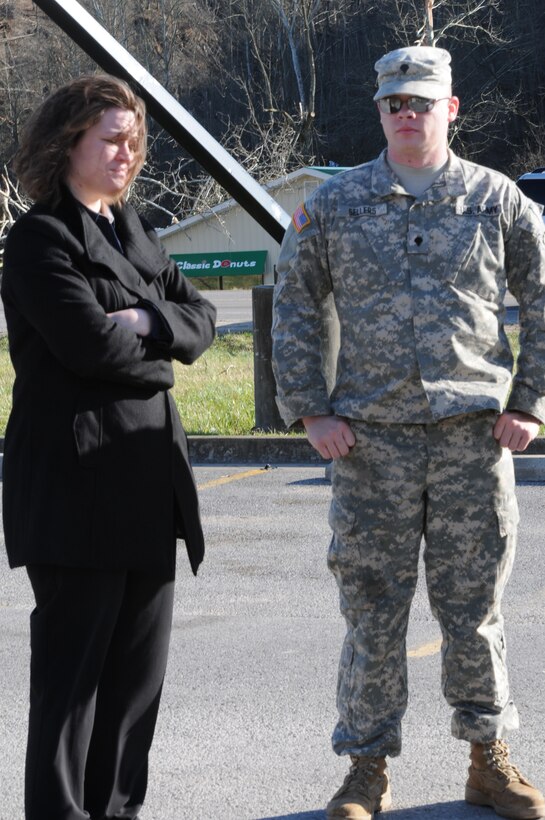 Spc. Matthew Sellers, Horizontal Engineer for the 207th Engineer Battalion, based in Hazard, Ky., speaks with Kenna Spears, district leader for Advance Auto Parts, in Salyersville, Ky., concerning the damage to local businesses in the area, March 3.