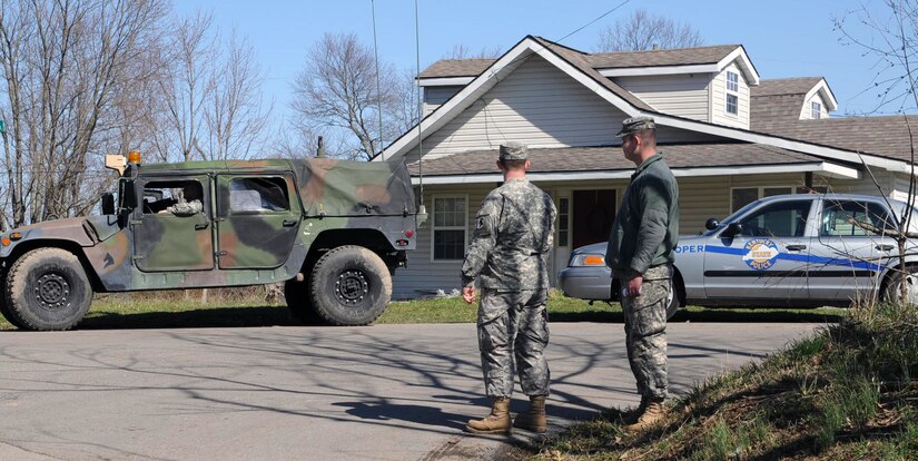 Kentucky Guardsmen from Charlie Battery 1st Battalion, 623rd Field Artillery (HIMARS) provide assistance to local authorities by pulling security, clearing debris, manning checkpoints and patrolling damaged areas in East Bernstadt, Ky., March 3.