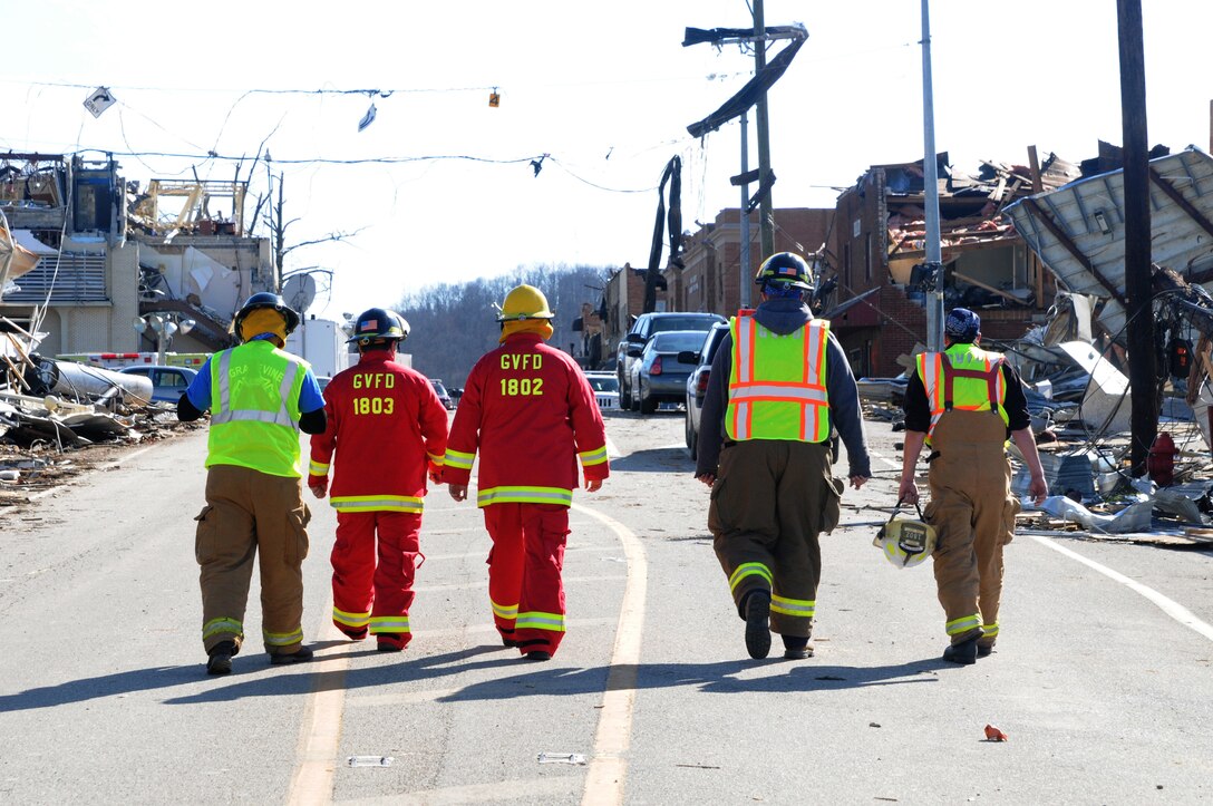 Firefighters from the Grape Vine Fire Department assist local and state law enforcement officials, along with Kentucky National Guard service members, in relief efforts taking place in West Liberty, Ky., where a series of tornadic storms demolished much of the city.