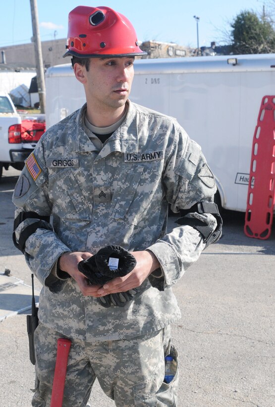 U.S. Army Sgt. Adam Griggs, a wheel mechanic with the 301st Chemical Company, stationed out of Morehead, Ky., prepares to go out on a search and rescue mission in West Liberty, Ky., to look for any survivors that may have been trapped under the debris of homes and structures, March 3, 2012.