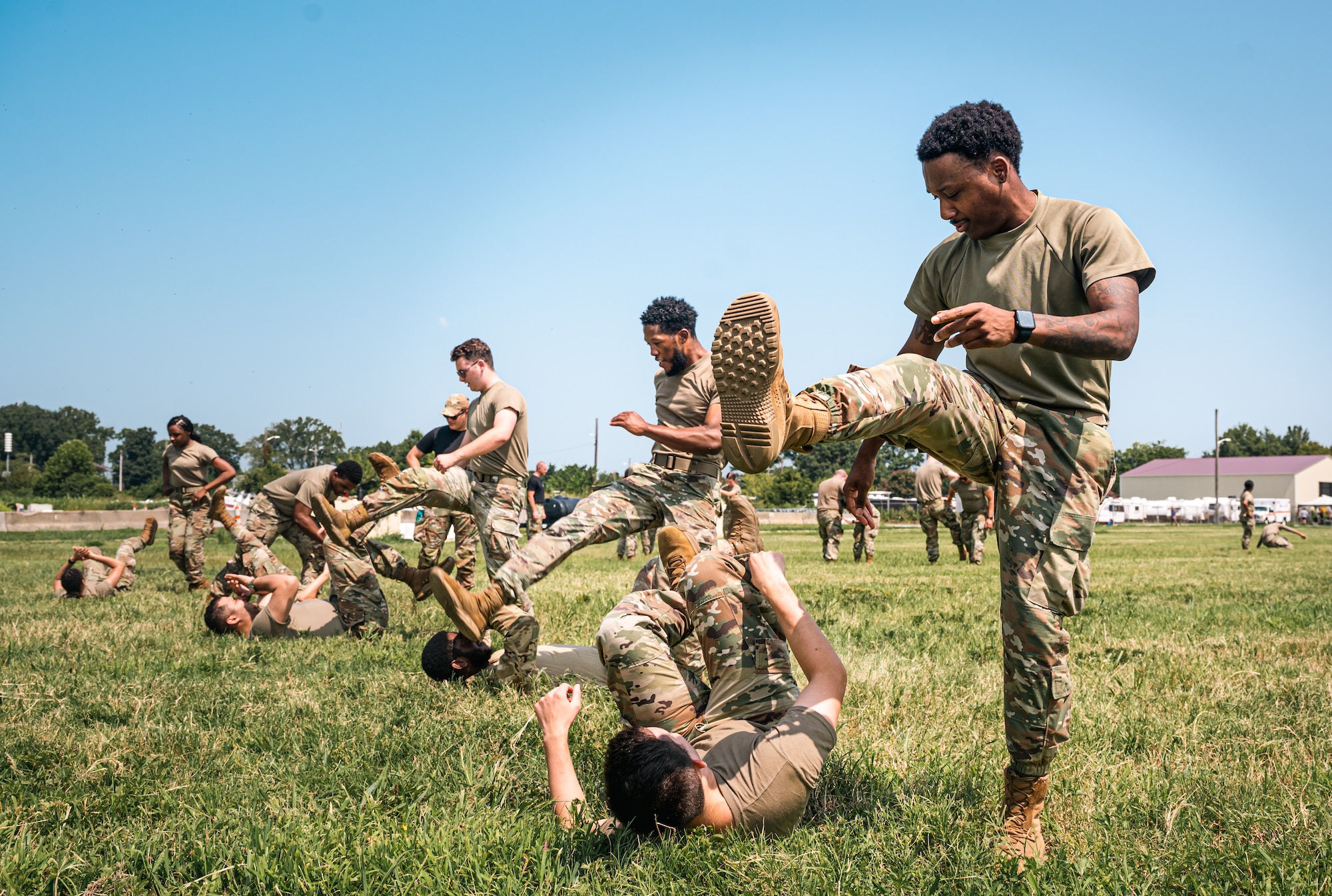 A row of Airmen prepare to stomp towards their opponents on the grass