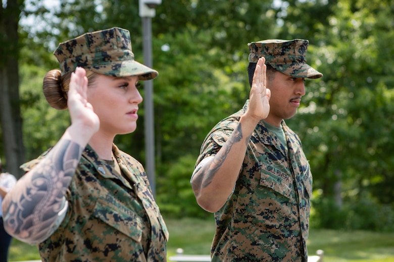 U.S. Marine Corps Sgt. Haley G. Gillrivera, a motor vehicle operator at The Basic School, left, and Cpl. Brandon Gillrivera, a motor vehicle operator at Officer Candidates School, recite the oath of enlistment during their reenlistment ceremony at the National Museum of the Marine Corps, Triangle, Virginia, Aug. 1, 2024. The Gillriveras are a dual-military couple who decided to reenlist together, continue to develop their individual careers, and utilize the benefits the Marine Corps has to offer to their family. (U.S. Marine Corps photo by Lance Cpl. Anthony Ramsey)