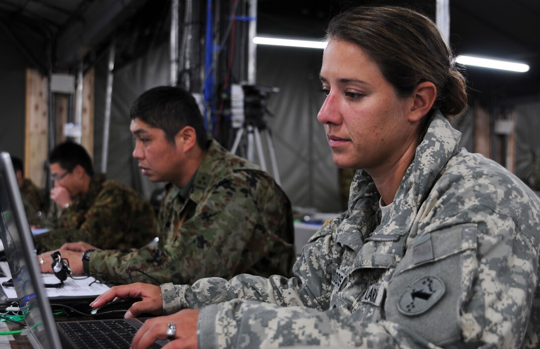 Capt. Brittany Woods, operations officer with the USARPAC Contingency Command Post, works side by side with Capt. Kousei Matunaga, exercise operations officer with the Exercise Plans and Operations Department in preparation for the Yama Sakura 61 exercise at Camp Itami in Osaka, Japan, Jan 23.