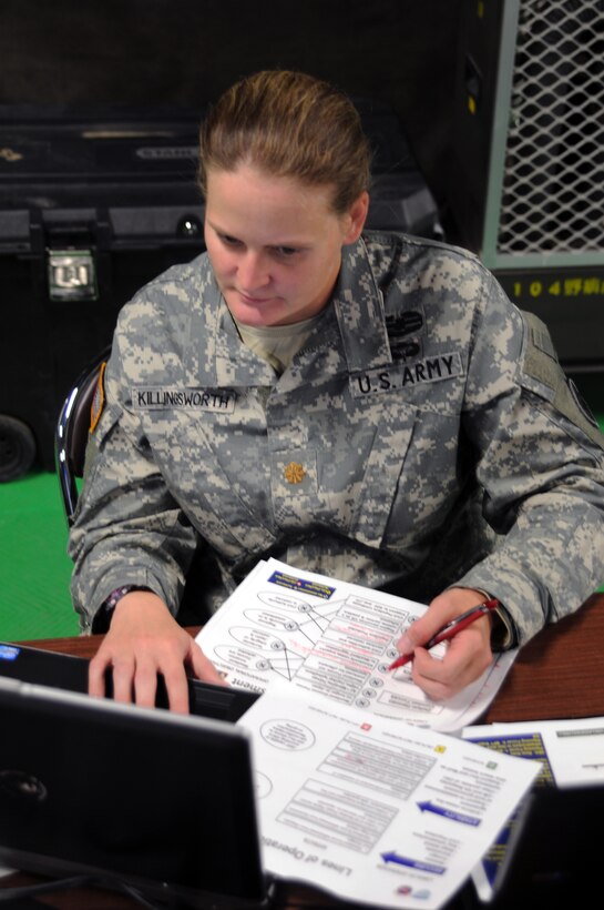 Maj. Miranda Killingsworth, civil affairs planner with U.S. Army Pacific Contingency Command Post, works on an operational chart during Yama Sakura 61 at Camp Itami in Osaka, Japan.