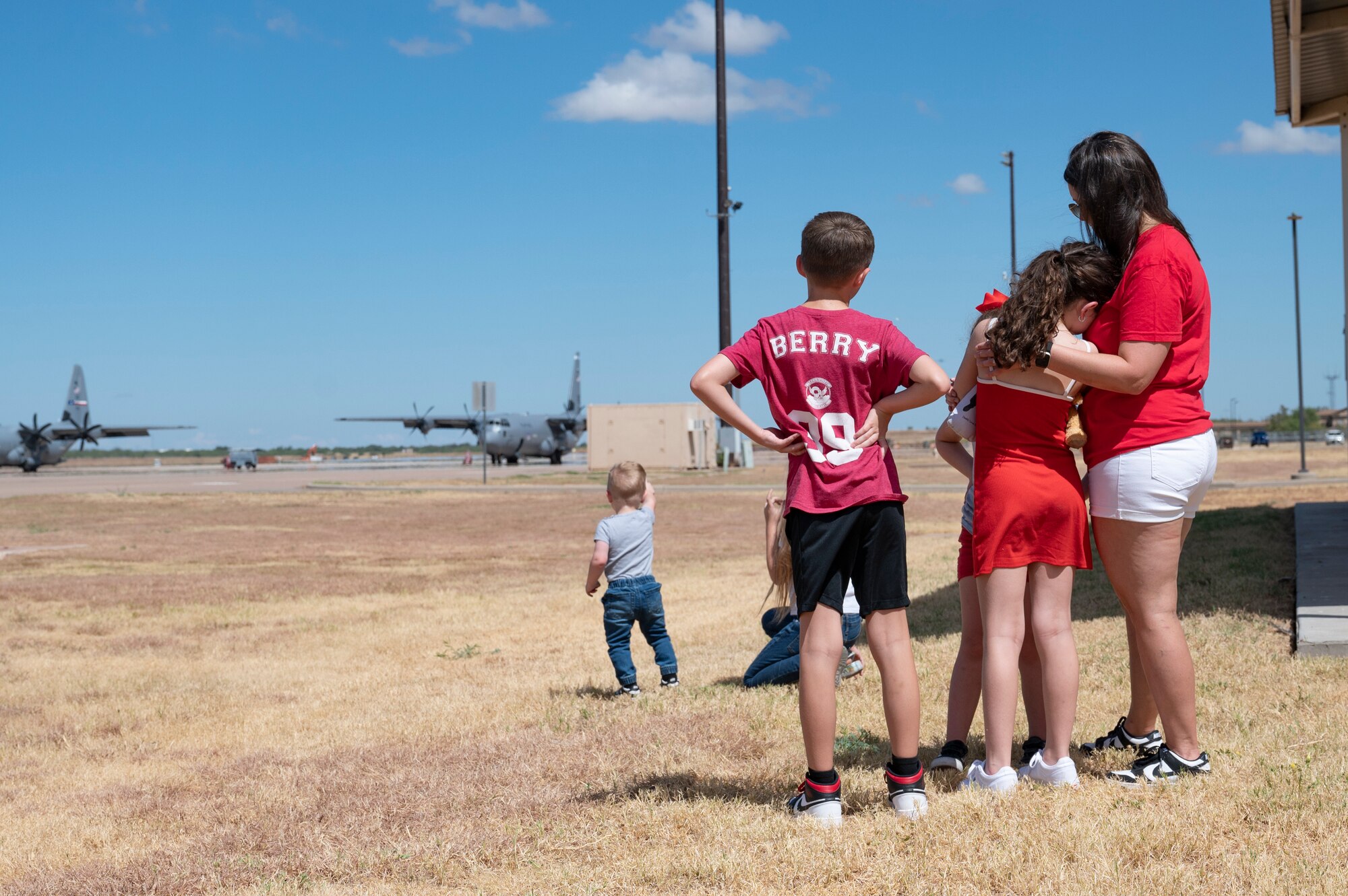 Family and friends of 317th Airlift Wing Airmen watch their loved ones depart for deployment at Dyess Air Force Base, Texas, Aug. 27, 2024. The 317th AW Rapid Global Mobility mission requires readiness to respond to worldwide requirements, as required and tasked through the U.S. Central Command and Air Mobility Command. (U.S. Air Force photo by Airman 1st Class Emma Anderson)