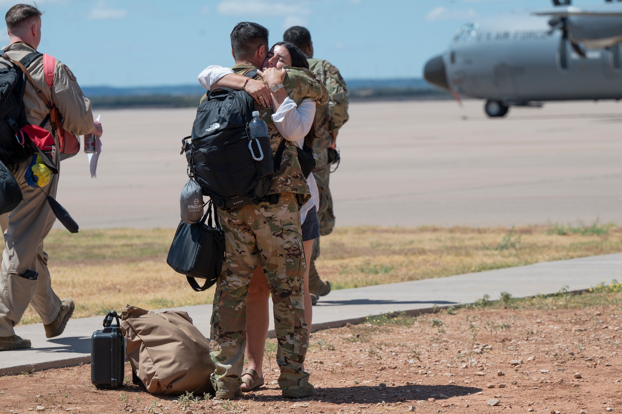 A 317th Airlift Wing Airman embraces a loved one before leaving for deployment at Dyess Air Force Base, Texas, Aug. 27, 2024. The 317th AW Rapid Global Mobility mission requires readiness to respond to worldwide requirements, as required and tasked through the U.S. Central Command and Air Mobility Command. (U.S. Air Force photo by Airman 1st Class Emma Anderson)