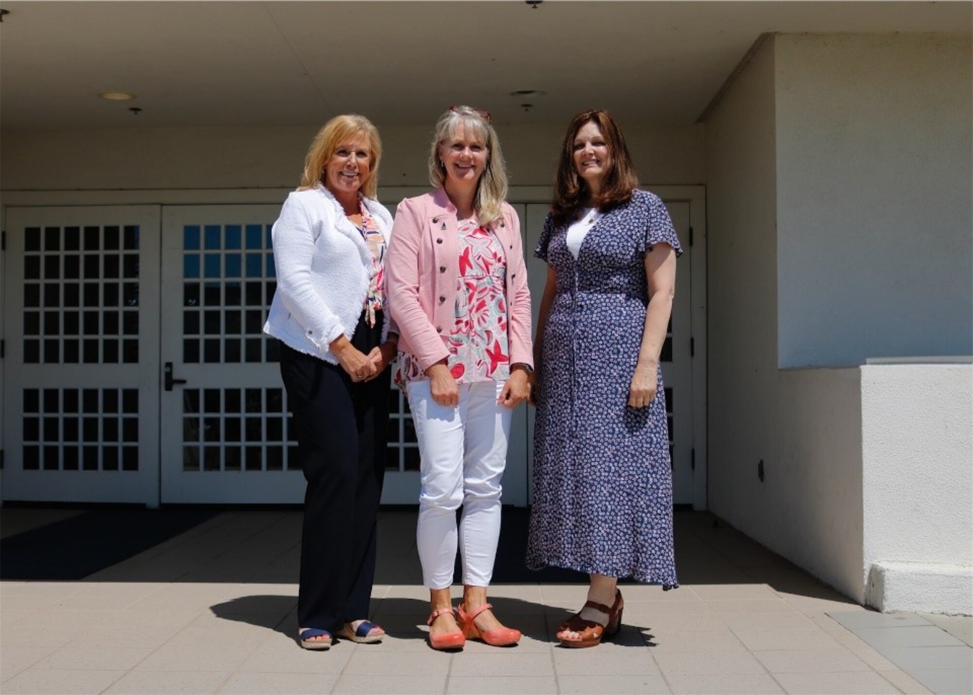 A Space Launch Delta 30 vice commander’s spouse, left, a Space Systems Command commander’s spouse, middle, and a Space Launch Delta 30 operations vice commander’s spouse, right, pose for a photo outside of the Pacific Coast Center at Vandenberg Space Force Base.