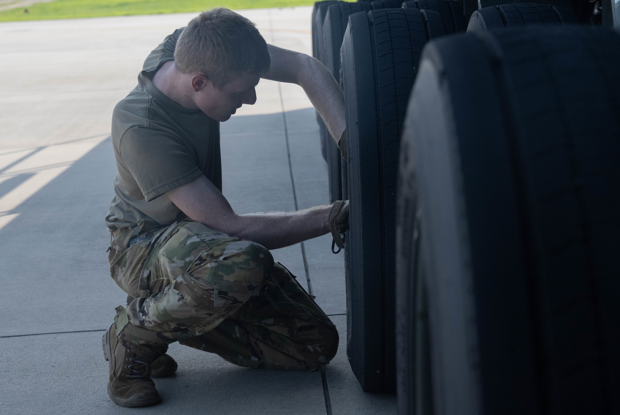 U.S. Airman removes air from tire