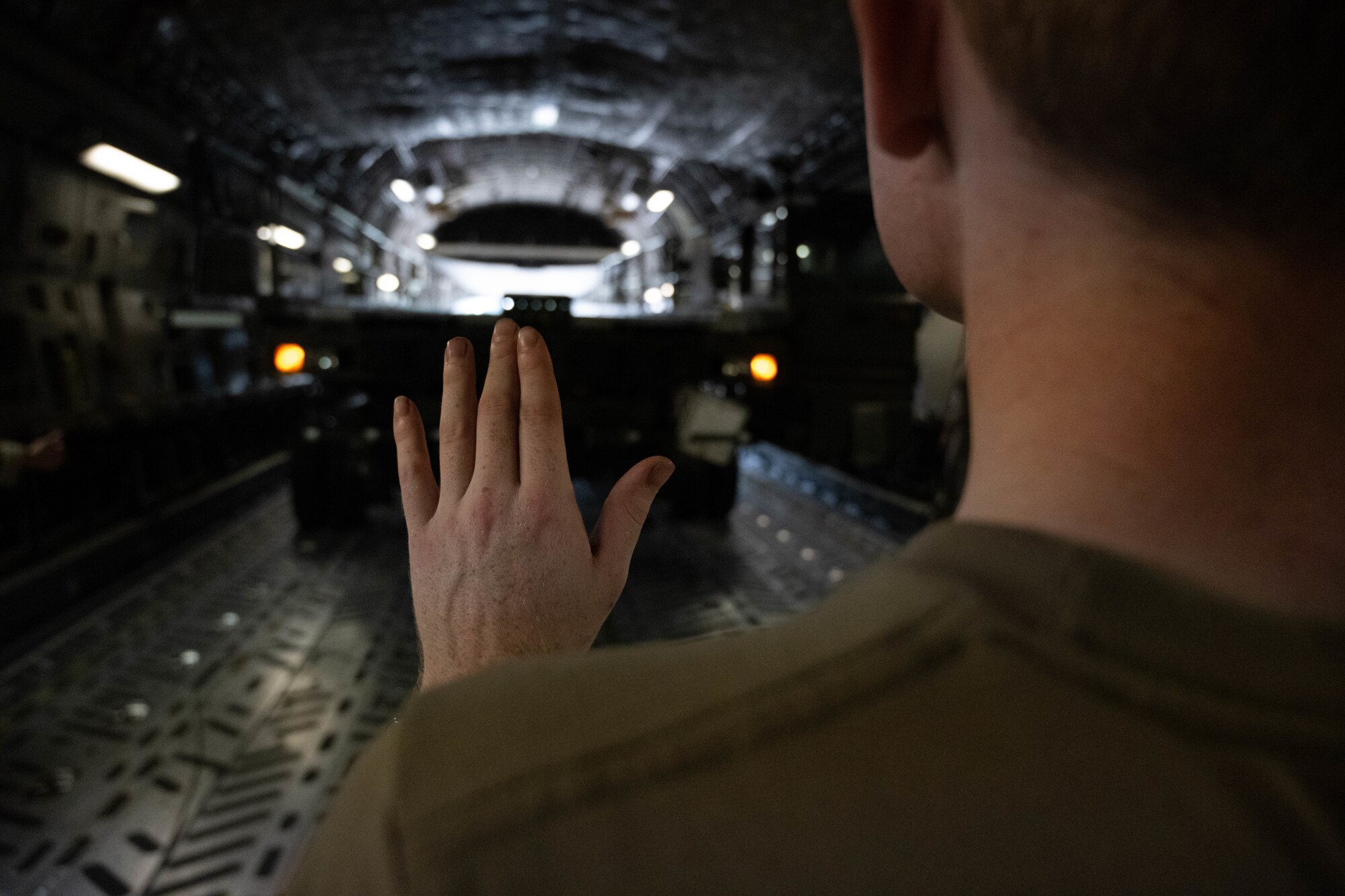 U.S. Airman marshals heavy equipment