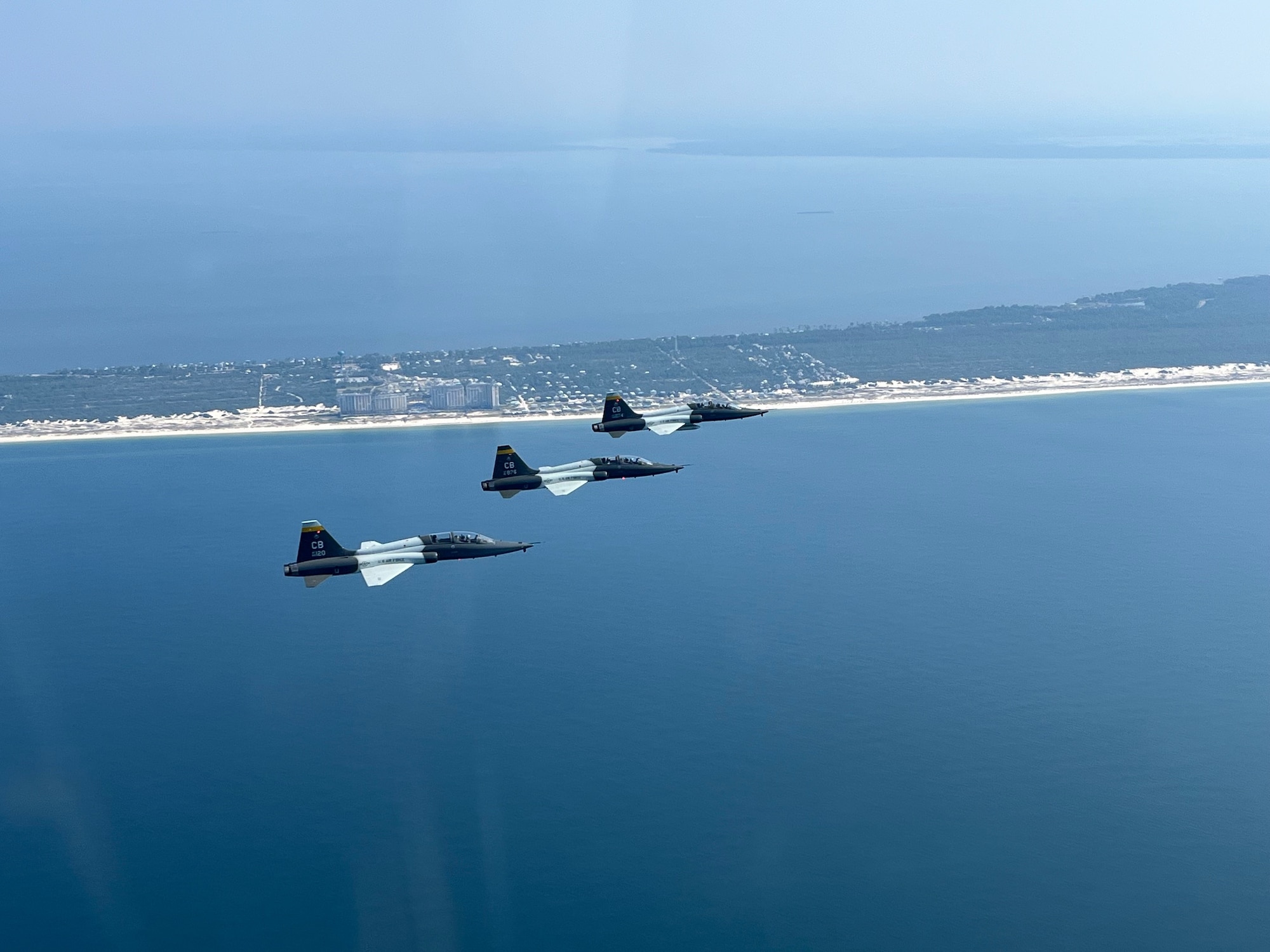 Aircraft from Columbus Air Force Base fly a formation pattern over an airfield in Florida.
