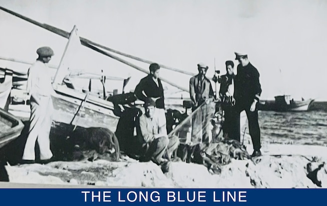 Photograph of a Sicilian fishermen preparing to return to sea describing to Lt. Pell the challenges of fishing in Italian waters. (U.S. Coast Guard photo by Cmdr. Clay Pell)