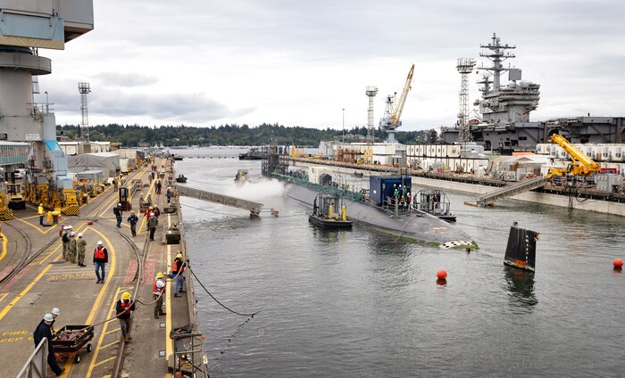 A team of Code 740, Riggers, helps guide USS Jimmy Carter (SSN 23) into Dry Dock 6, Aug. 21, 2024, in preparation for the submarines Fiscal Year 24 Docking Continuous Maintenance Availability at Puget Sound Naval Shipyard & Intermediate Maintenance Facility in Bremerton, Washington. (U.S. Navy photo by Wendy Hallmark)