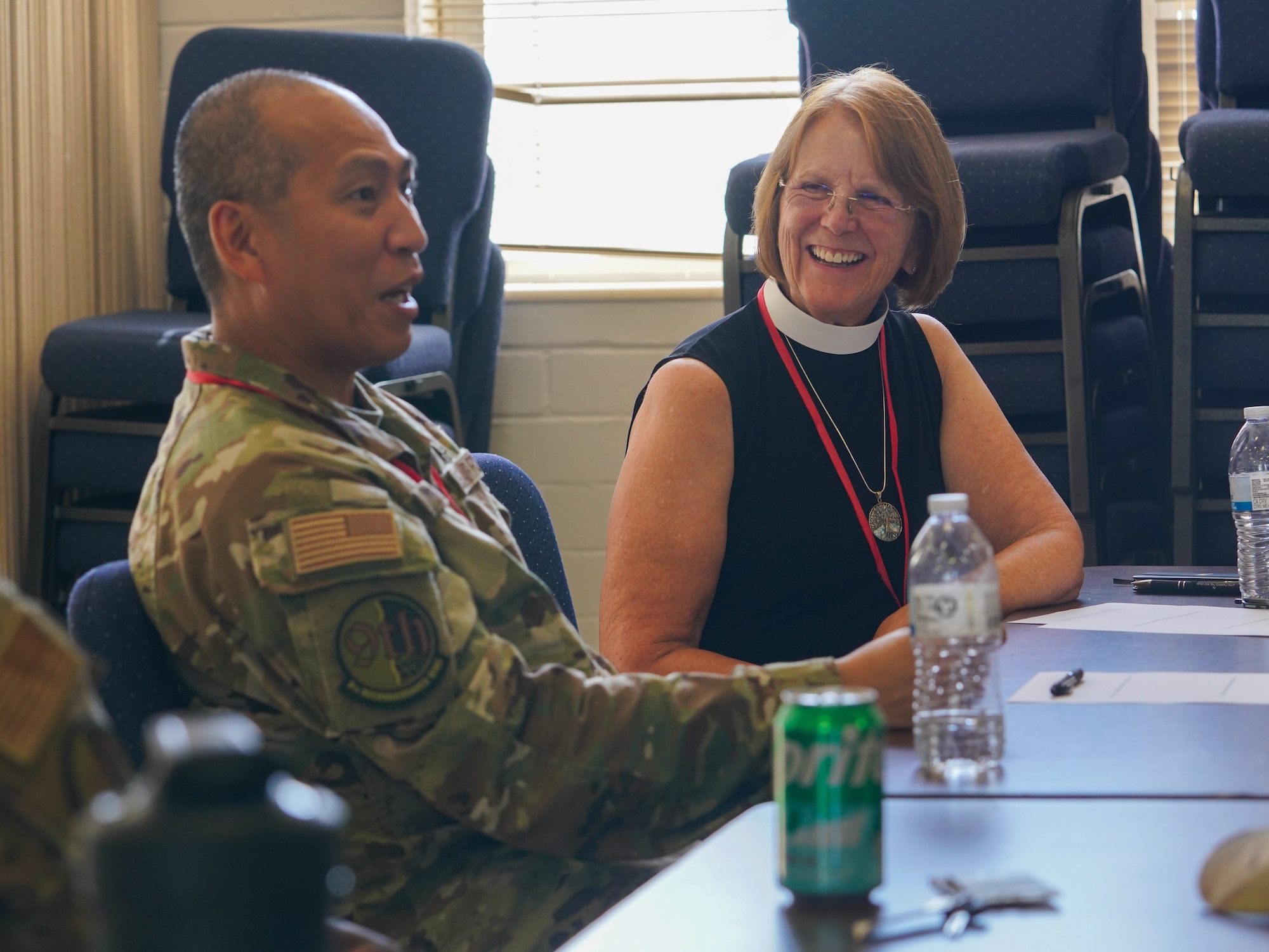 U.S. Air Force Maj. Angeles De Leon, 9th Reconnaissance Wing deputy wing chaplain, and Carolyn Brodt, Bethel Lutheran Church pastor, discuss ways they can collaborate on supporting service members spiritually on and off base during Clergy Day at Beale Air Force Base, California, Aug. 28, 2024.