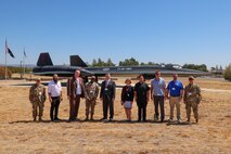 The 9th Reconnaissance Wing Chapel Corps and members from various clergies and faiths pose for a group photo in front of an SR-71 Blackbird static display during Clergy Day at Beale Air Force Base, California, Aug. 28, 2024.