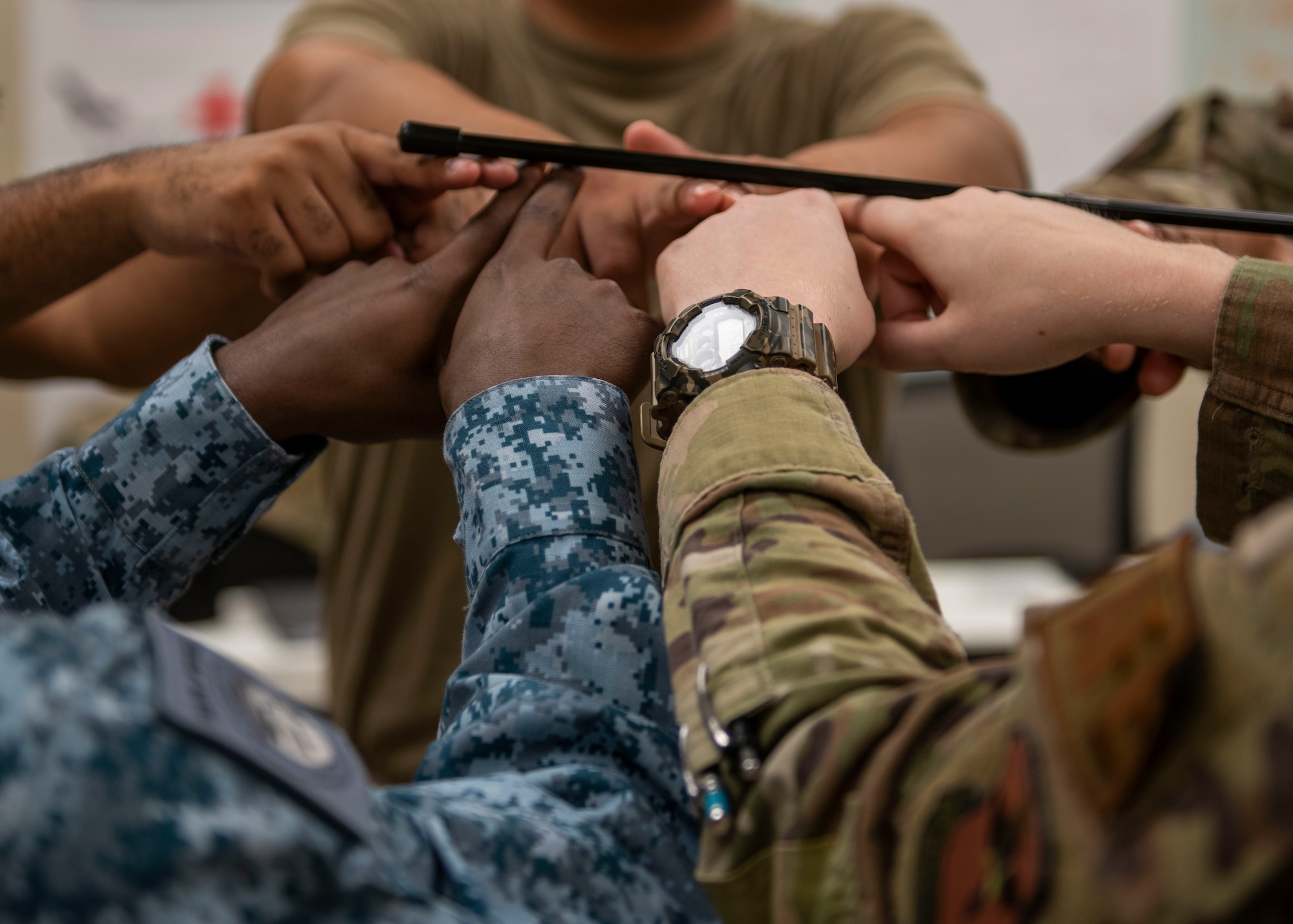 Republic of Singapore Air Force Military Expert 1-2 Bala Krishnan Suriyah, 425th Fighter Squadron F-16 crew chief, and the rest of Luke Air Force Base’s John J, Rhodes Airman Leadership School Falcon Flight class, perform a team building exercise during ALS, Aug. 16, 2024, at Luke AFB, Arizona.
