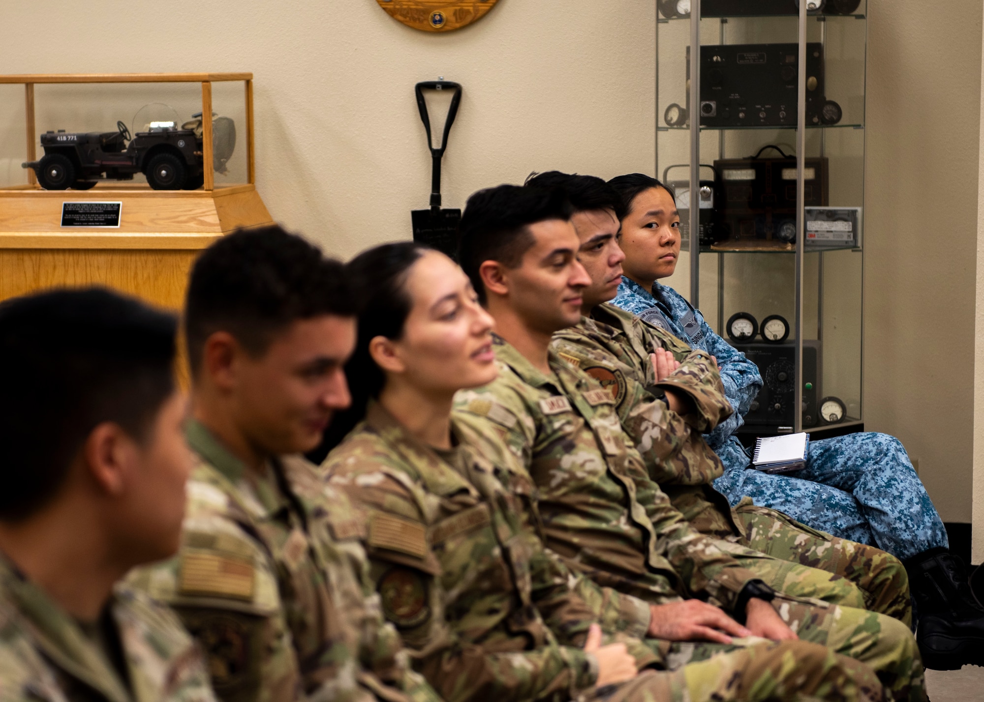 Republic of Singapore Air Force Military Expert 1-2 Angel Lim (far right), 425th Fighter Squadron F-16 weapons load crew member, listens to a National Defense Strategy brief at John J. Rhodes Airman Leadership School, Aug. 19, 2024, at Luke Air Force Base, Arizona.