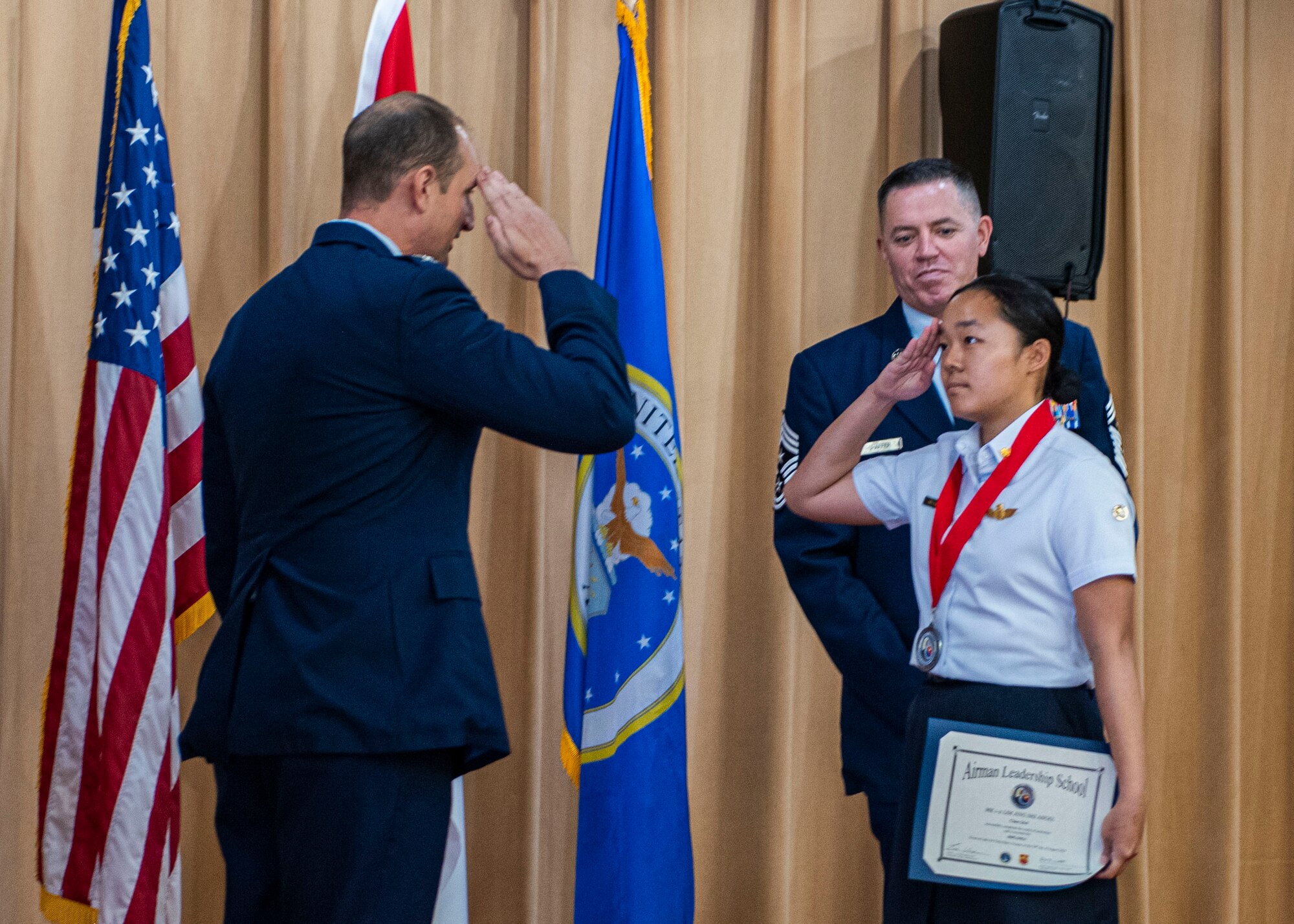Republic of Singapore Air Force Military Expert 1-2 Angel Lim (right), 425th Fighter Squadron F-16 weapons load crew member, salutes U.S. Air Force Col. Matthew Johnston, 56th Fighter Wing deputy commander, Aug. 29, 2024, at Luke Air Force Base, Arizona.