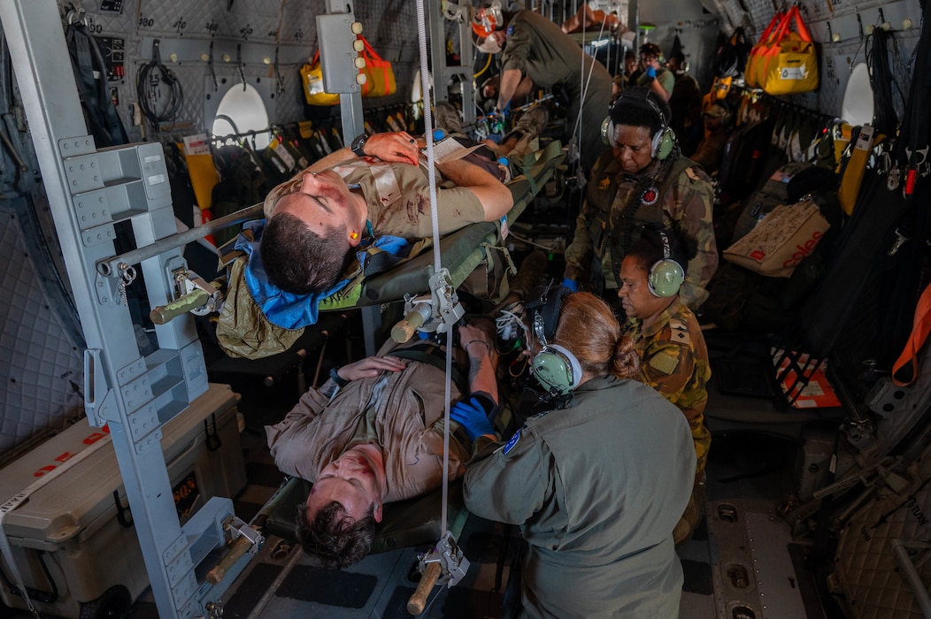 Royal Australian Air Force and Papua New Guinea Defence Force medical personnel practice rendering first aid on a RAAF C-27J Spartan mid-flight during Pacific Angel 24-1 at Papua New Guinea, Aug. 29, 2024. Pacific Angel 24-1 focuses on exchanging and teaching tactics and techniques between the participating countries. (U.S. Air Force photo by Airman 1st Class Carson Jeney)