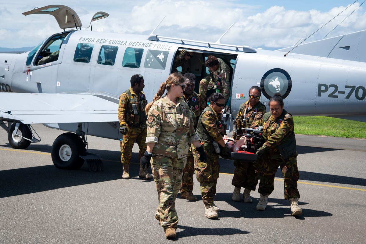 U.S. Air Force and Papua New Guinea Defence Force aeromedical evacuation personnel remove a simulated casualty from a PNGDF PAC-750 during Pacific Angel 24-1 at Lae, Papua New Guinea, Aug. 29, 2024. U.S. Air Force, Royal Australian Air Force and Papua New Guinea Defence Force personnel culminated three days of aeromedical evacuation training and subject matter expert exchanges with a field training exercise. Pacific Angel is a series of joint, combined and bilateral humanitarian response exercises that supports U.S. Indo-Pacific Command objectives, U.S. Pacific Air Forces strategy and respective U.S. Embassy Strategic Engagement objectives. (U.S. Air Force photo by Senior Master Sgt. DeAndre Curtiss)