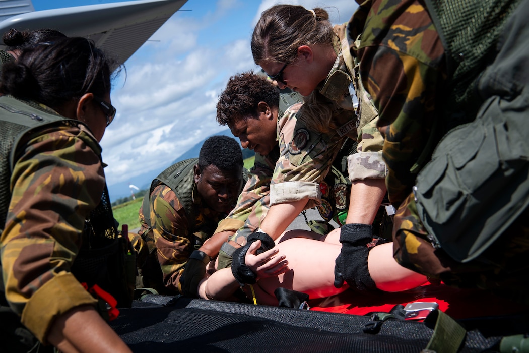 U.S. Air Force and Papua New Guinea Defence Force aeromedical evacuation personnel prepare a simulated casualty for transport during Pacific Angel 24-1 at Lae, Papua New Guinea, Aug. 29, 2024. U.S. Air Force, Royal Australian Air Force and Papua New Guinea Defence Force personnel culminated three days of aeromedical evacuation training and subject matter expert exchanges with a field training exercise. Pacific Angel is a series of joint, combined and bilateral humanitarian response exercises that supports U.S. Indo-Pacific Command objectives, U.S. Pacific Air Forces strategy and respective U.S. Embassy Strategic Engagement objectives. (U.S. Air Force photo by Senior Master Sgt. DeAndre Curtiss)