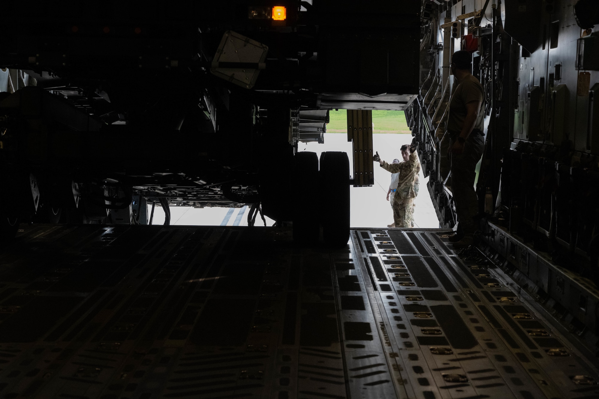 U.S. Airman marshals heavy equipment