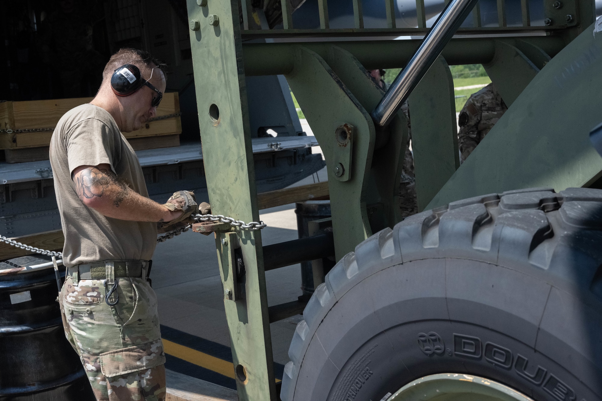 U.S. Airman prepares piece of heavy equipment