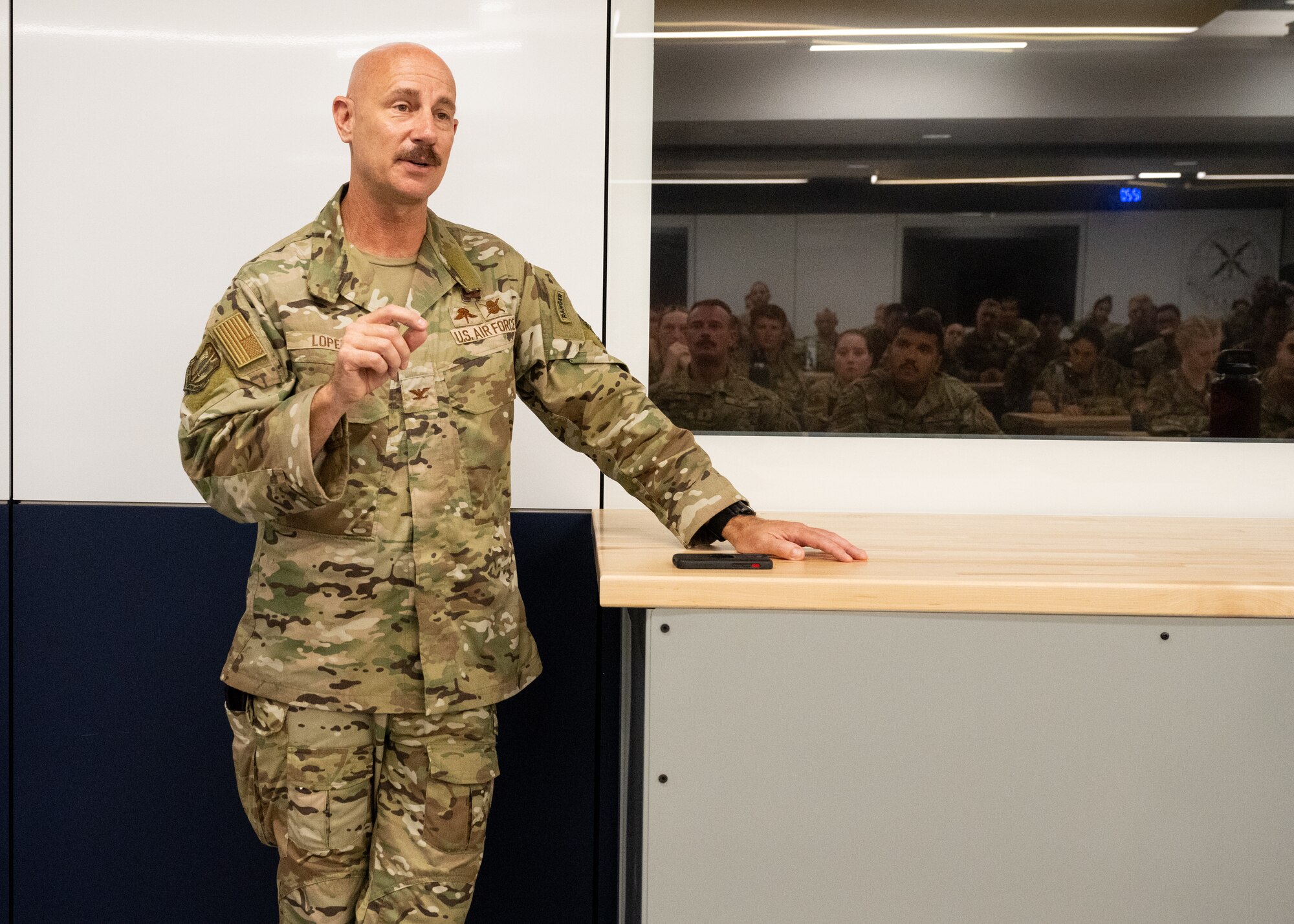 An Air Force Colonel speaks to a group of recruiters