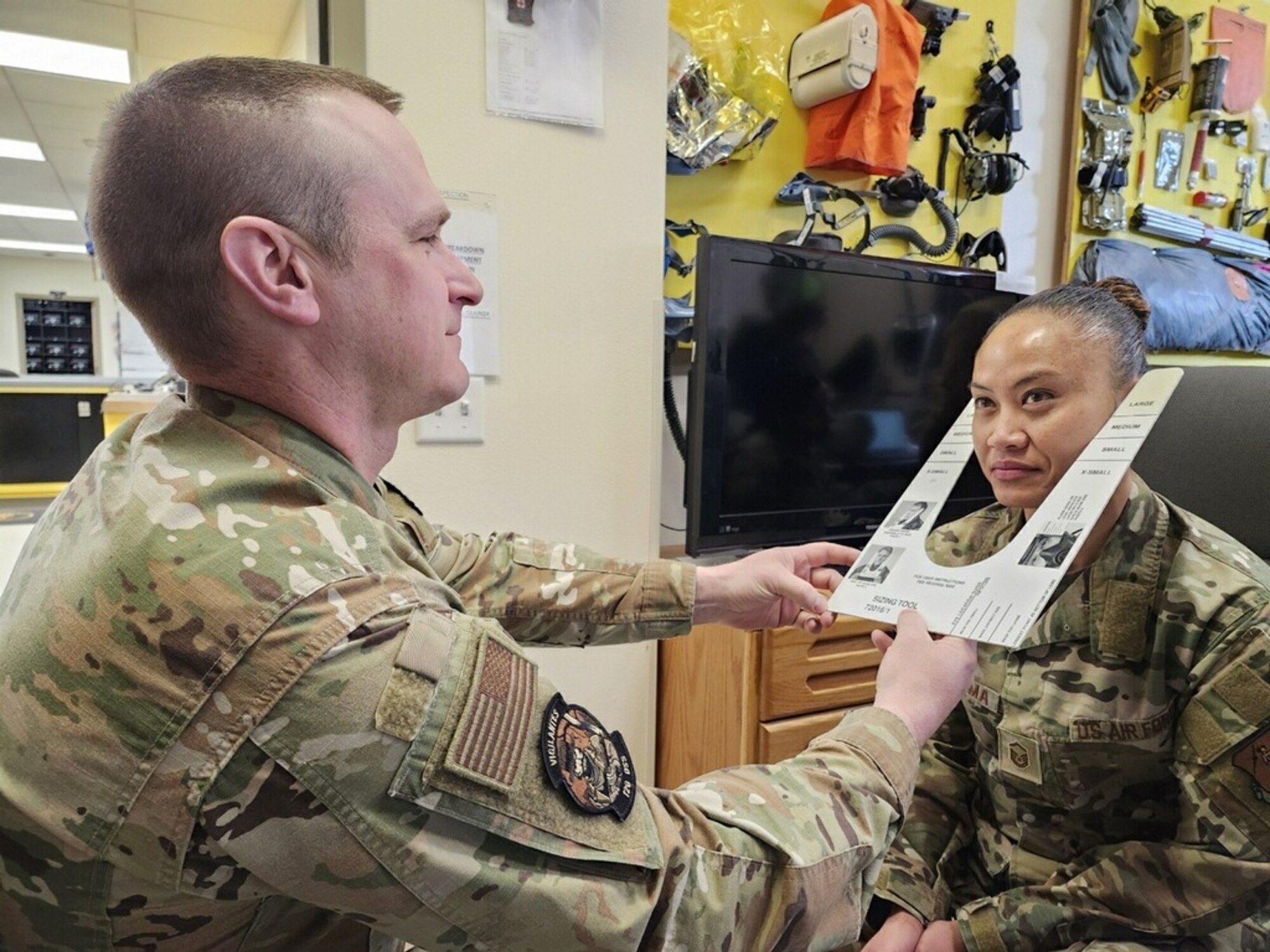 Senior Master Sgt. Neil Kolve, Aircrew Flight Equipment Superintendent for the 120th OSS Squadron, fits Master Sgt. Jacklyn Sugiyama for the Joint Service Aircrew Mask – Strategic Aircraft. (U.S. Air Force photo by Dr. Mohamed Mughal)