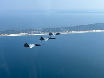Aircraft from Columbus Air Force Base fly a formation pattern over an airfield in Florida.