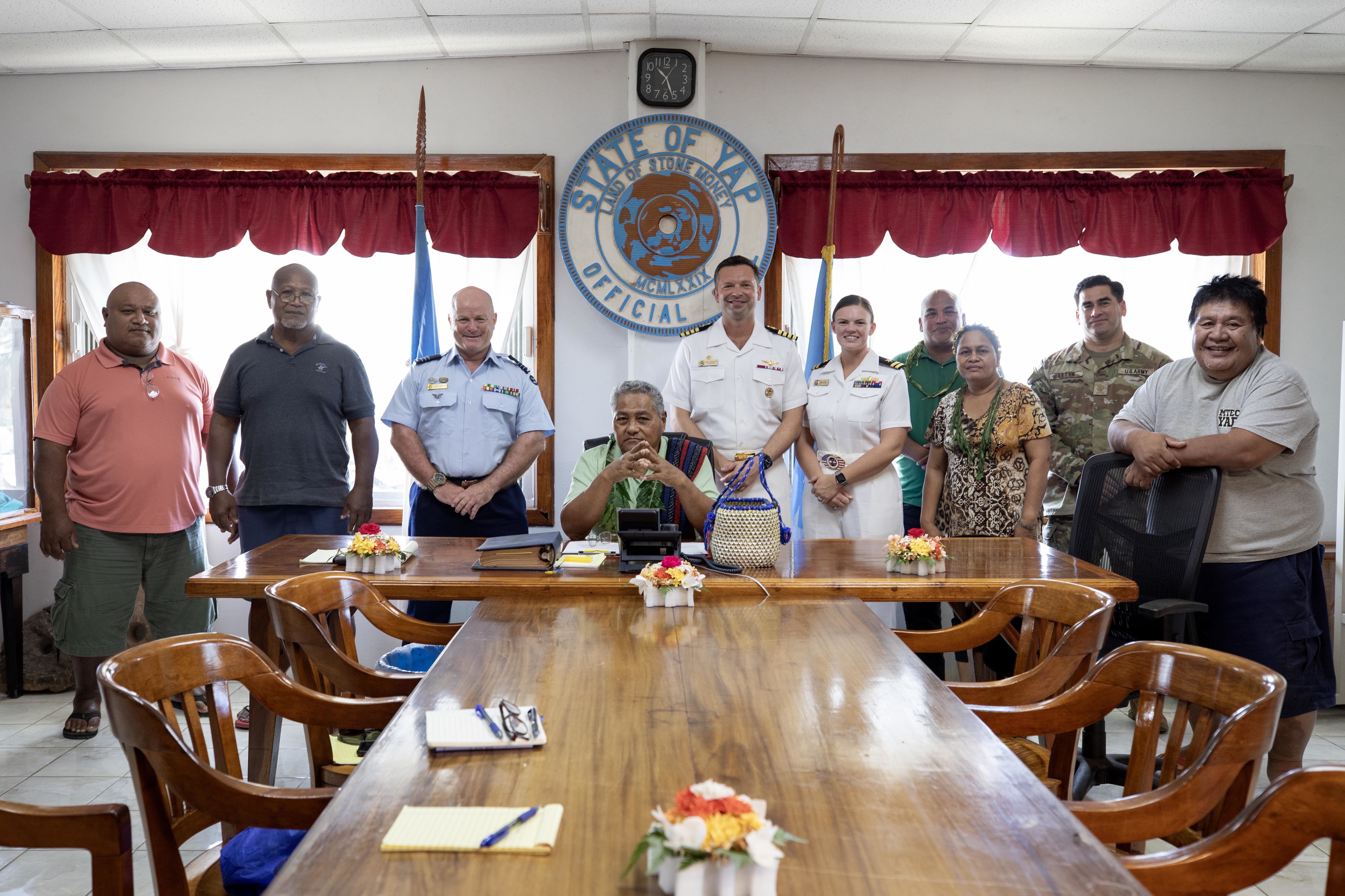 YAP, Federated States of Micronesia (Sep. 04, 2024) – Mr. Charles Chieng, center, Yap governor, Federated States of Micronesia, U.S. Navy Capt. Daniel Keeler, center right, Pacific Partnership 2024-2 (PP24-2) mission commander, to his right, U.S. Navy Lt. Maeve Sullivan, Yap PP24-2 officer in charge, and Royal Australian Air Force Wing Cmdr. Scott Minchin, center left, PP24-2 deputy mission commander, pose for a photo with Yap leadership during a meeting at the governor’s office, Sep. 04, 2024. Now in its 20th iteration, the Pacific Partnership series is the largest annual multinational humanitarian assistance and disaster relief preparedness mission conducted in the Indo-Pacific. Pacific Partnership works collaboratively with host and partner nations to enhance regional interoperability and disaster response capabilities, increase security and stability in the region, and foster new and enduring friendships in the Indo-Pacific. (U.S. Navy photo by Mass Communication Specialist 1st Class Ryan D. McLearnon/Released)